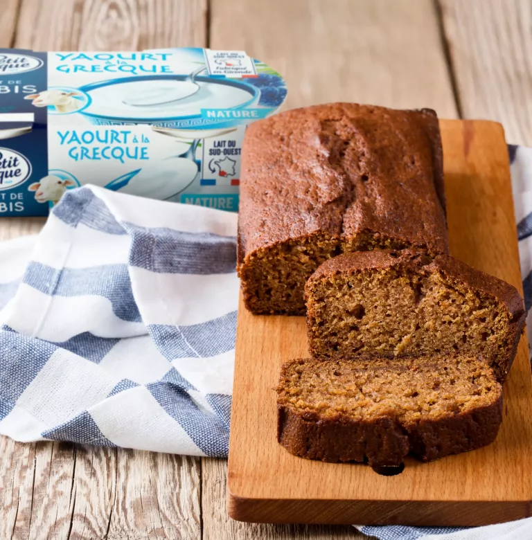 Homemade freshly baked pumpkin cake on rustic wooden board, sliced and ready to eat